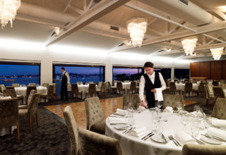 Sergeants Mess Sydney main dining room with waiter setting table